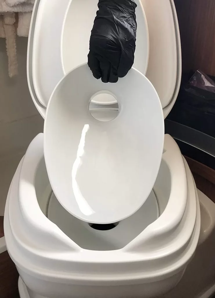 Porcelain insert being lowered into a cassette toilet.